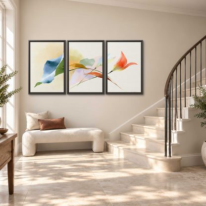 Airy green, orange and blue organic shapes floating across a white background 3 piece framed canvas wall art styled in an interior