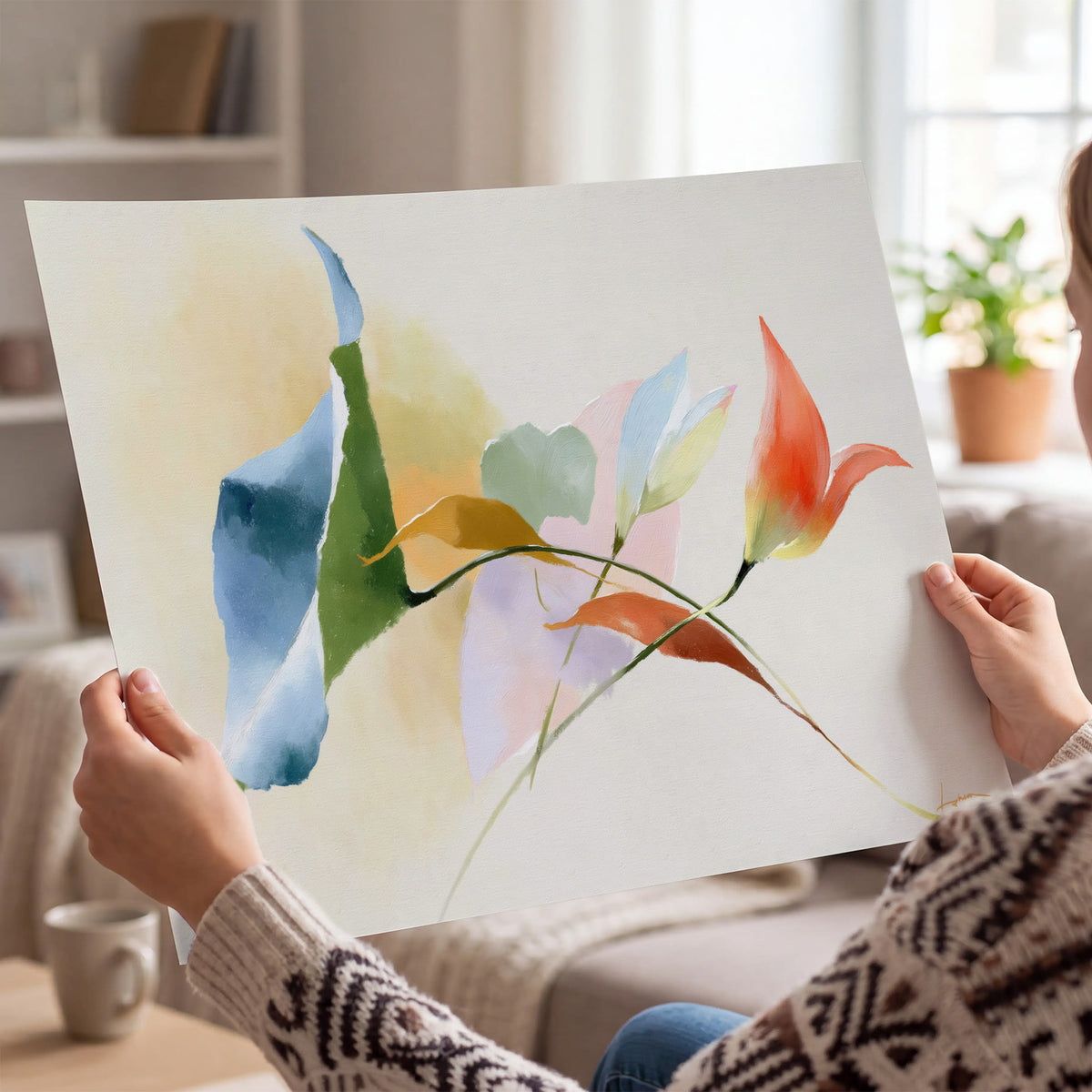 Airy green, orange and blue organic shapes floating across a white background single poster print held in hands