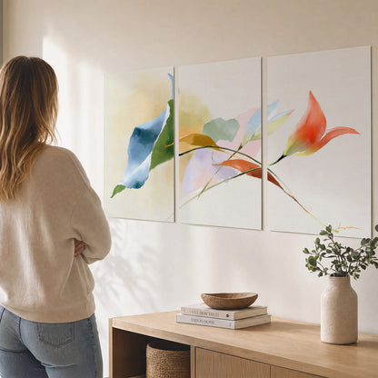 Airy green, orange and blue organic shapes floating across a white background set of 3 poster prints three panel arrangement on a wall