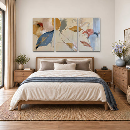 Loose ochre, blue and pink leaves arranged on a pale layered background 3 piece canvas wall art styled in an interior