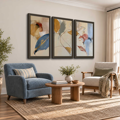 Loose ochre, blue and pink leaves arranged on a pale layered background 3 piece framed canvas wall art styled in an interior