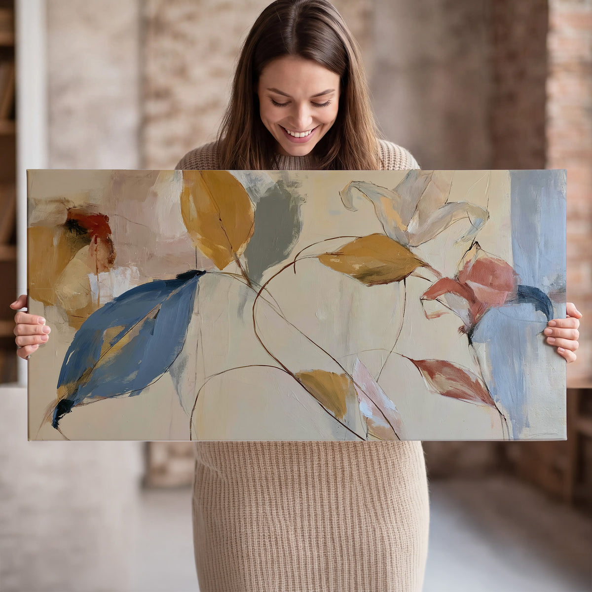 Loose ochre, blue and pink leaves arranged on a pale layered background single canvas wall art held in hands