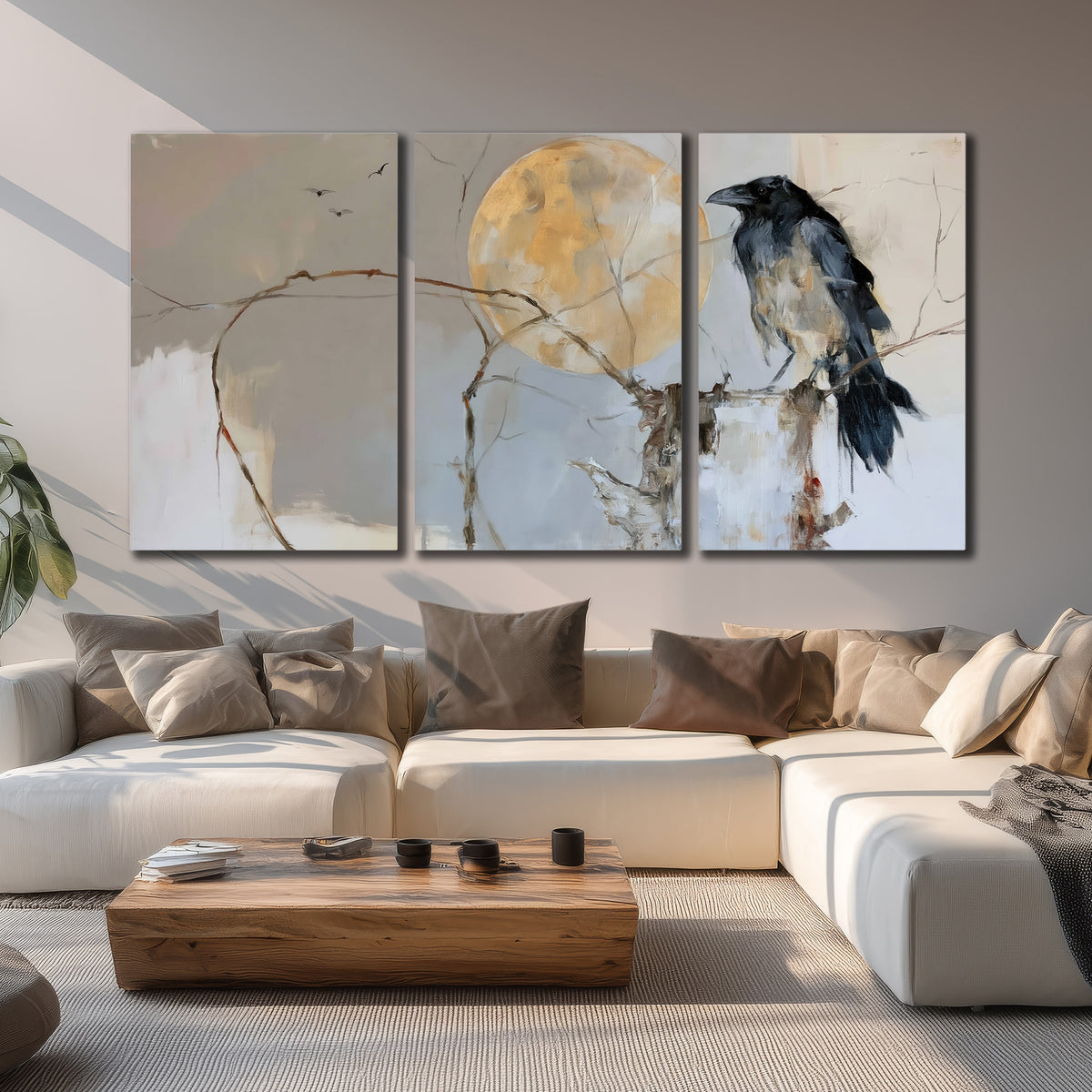 A dark raven beside a golden moon amid pale blue and cream painterly strokes 3 piece canvas wall art displayed in a living room