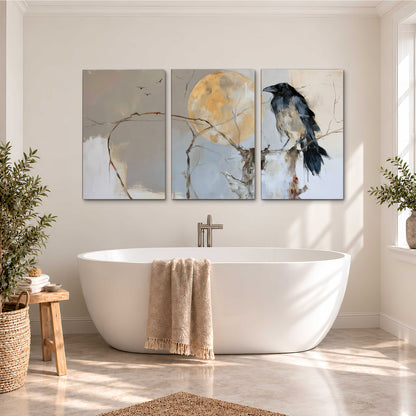 A dark raven beside a golden moon amid pale blue and cream painterly strokes 3 piece canvas wall art styled in an interior