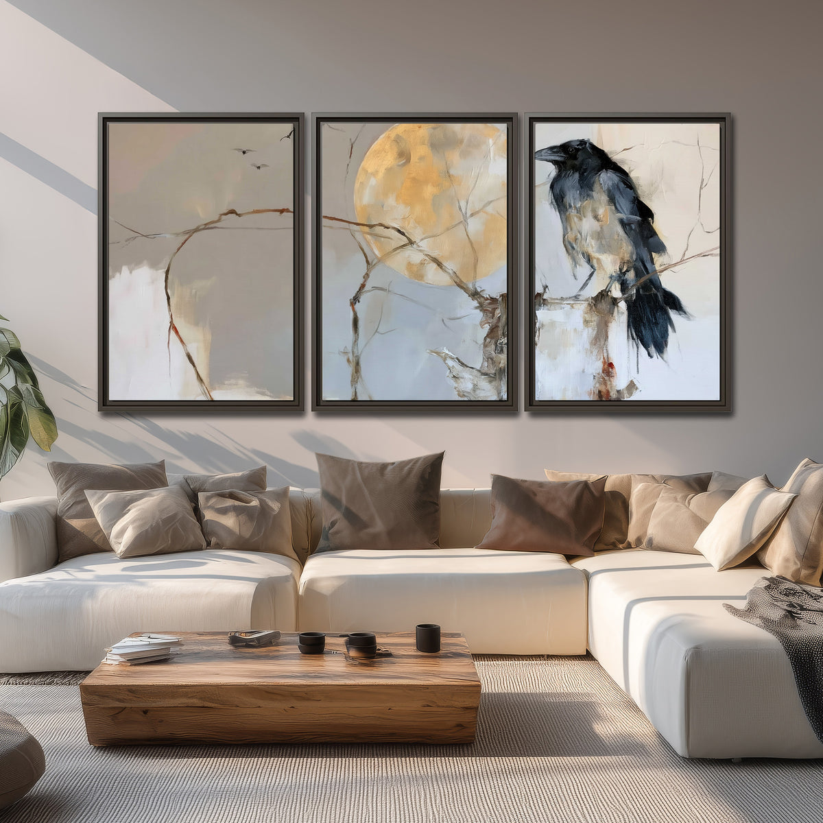 A dark raven beside a golden moon amid pale blue and cream painterly strokes 3 piece framed canvas wall art displayed in a living room