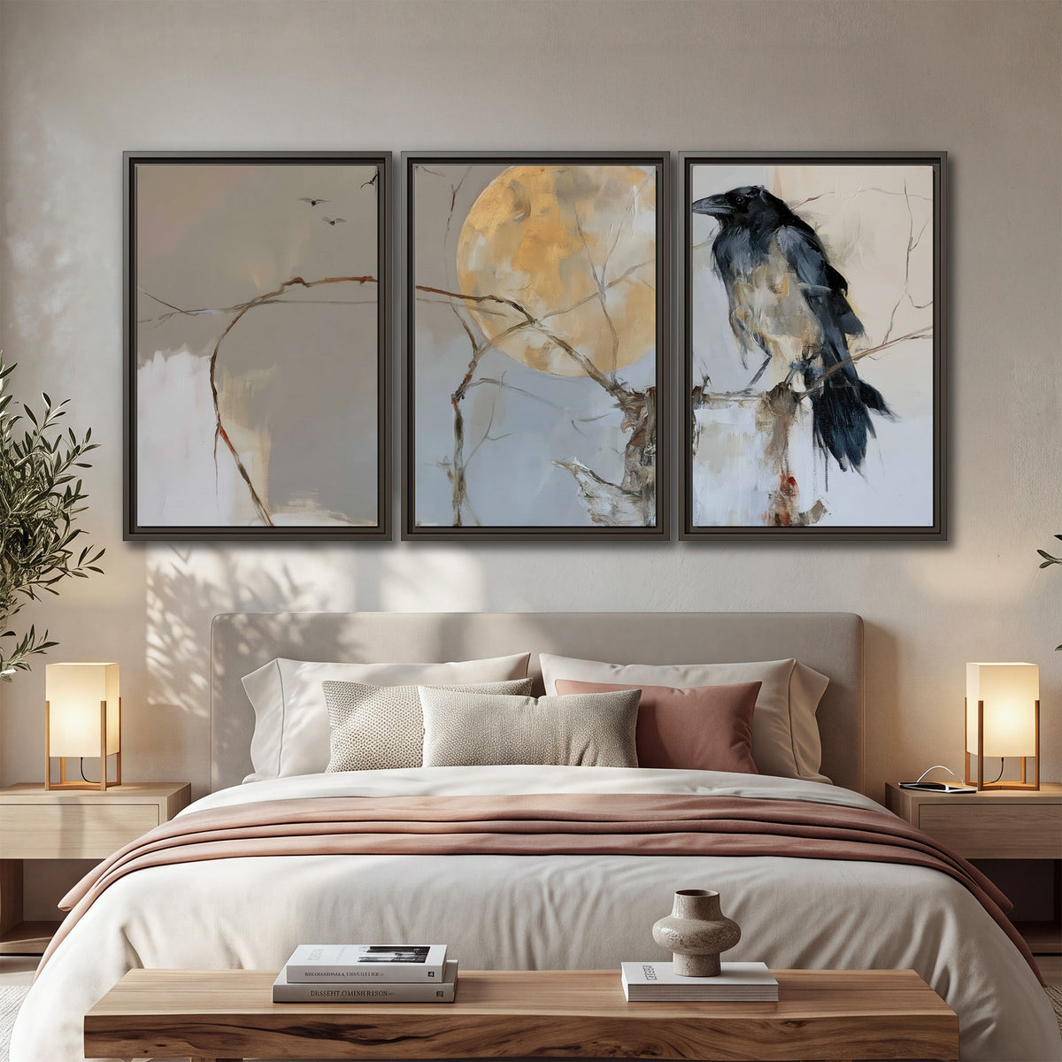 A dark raven beside a golden moon amid pale blue and cream painterly strokes 3 piece framed canvas wall art displayed in a bedroom