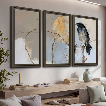 A dark raven beside a golden moon amid pale blue and cream painterly strokes 3 piece framed canvas wall art displayed in a console