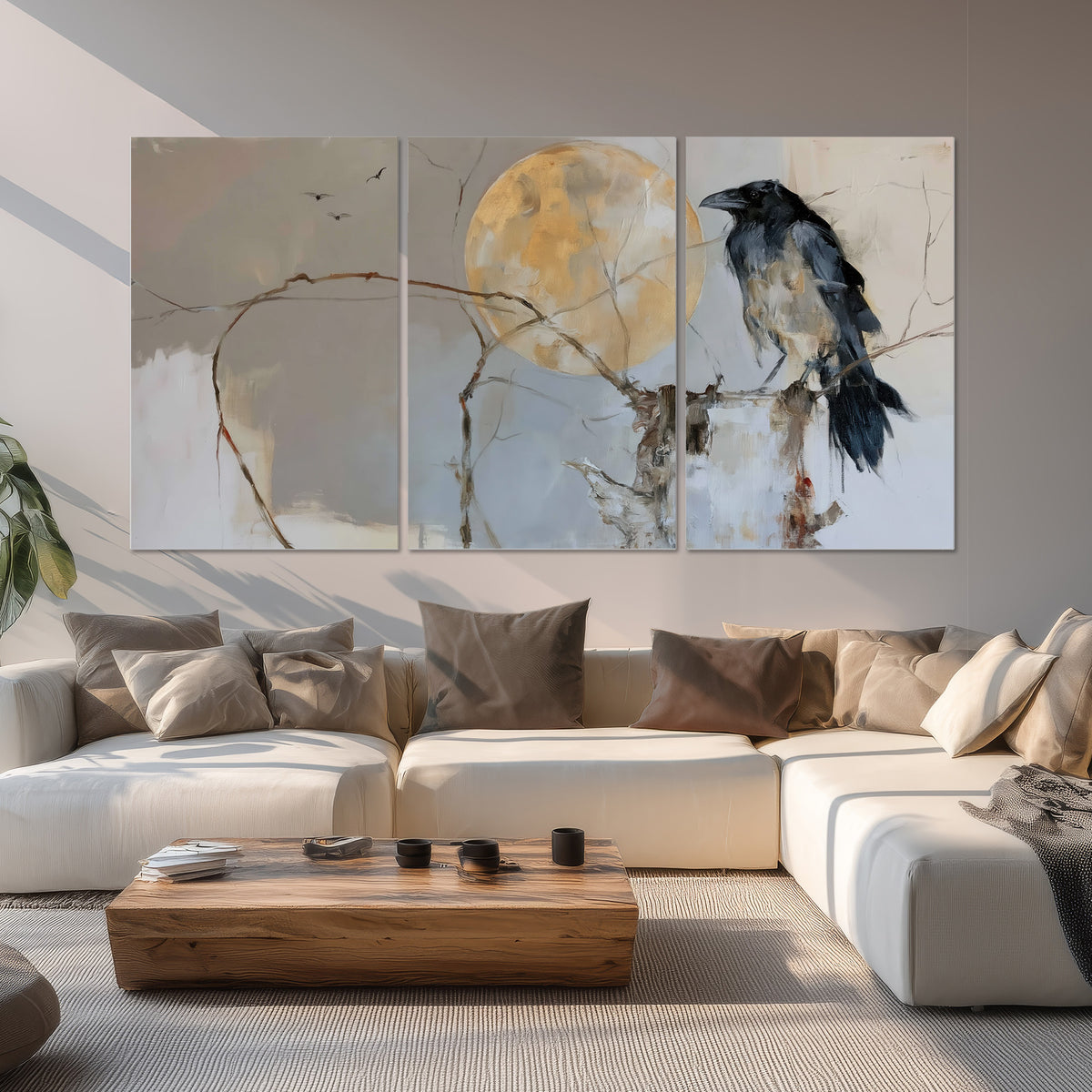 A dark raven beside a golden moon amid pale blue and cream painterly strokes set of 3 poster prints displayed in a living room