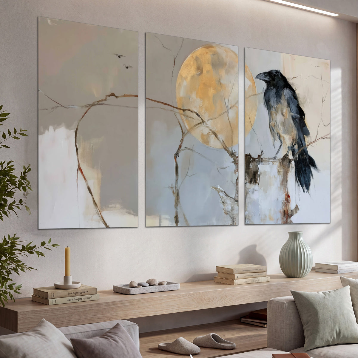 A dark raven beside a golden moon amid pale blue and cream painterly strokes set of 3 poster prints displayed in a console