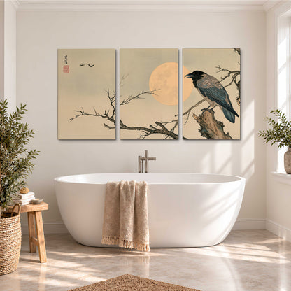 A dark raven perched on a bare branch beside a warm full moon 3 piece canvas wall art styled in an interior