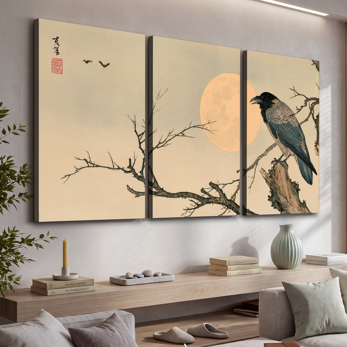A dark raven perched on a bare branch beside a warm full moon 3 piece canvas wall art displayed in a console
