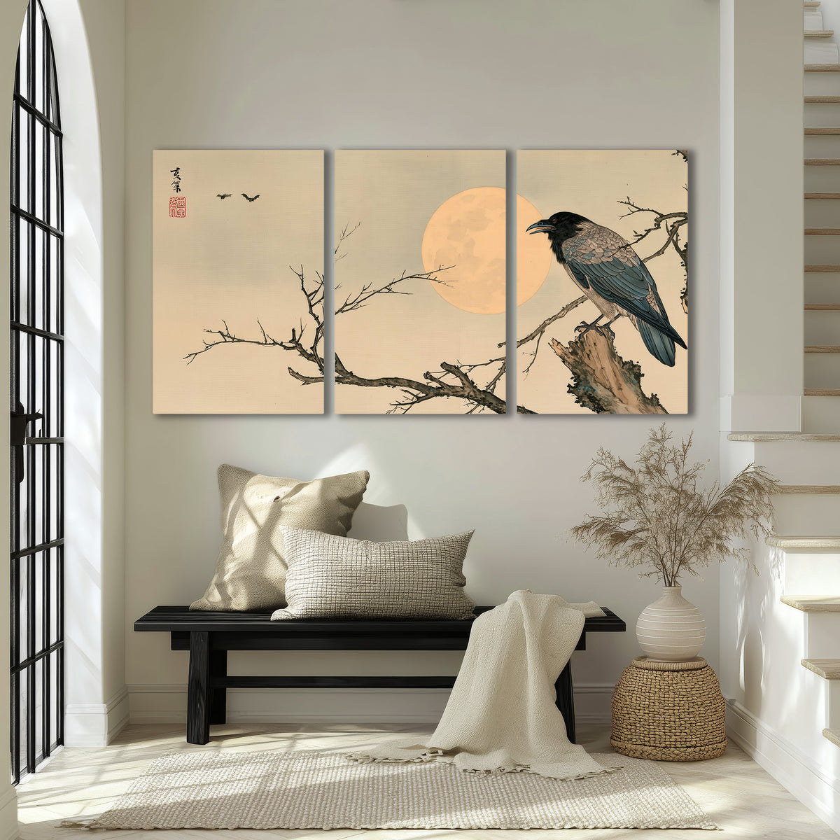 A dark raven perched on a bare branch beside a warm full moon 3 piece canvas wall art displayed in a entryway