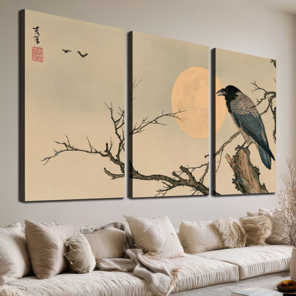 A dark raven perched on a bare branch beside a warm full moon 3 piece canvas wall art room and product view