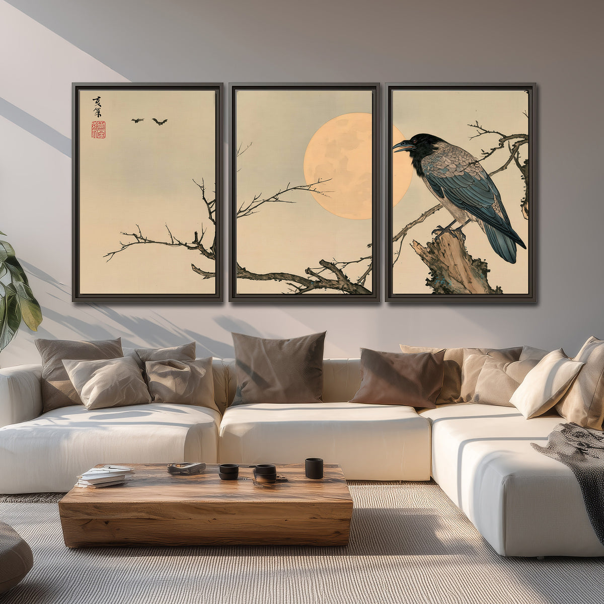 A dark raven perched on a bare branch beside a warm full moon 3 piece framed canvas wall art displayed in a living room