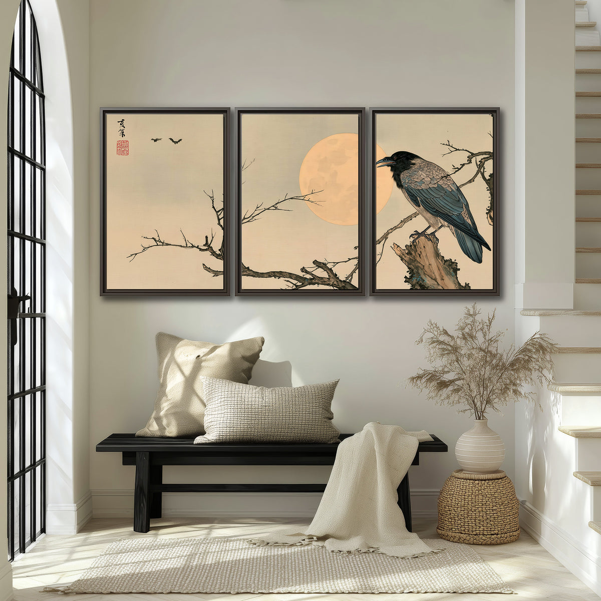 A dark raven perched on a bare branch beside a warm full moon 3 piece framed canvas wall art displayed in a entryway