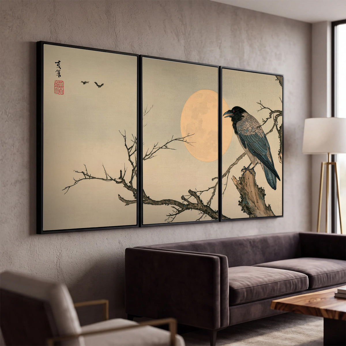 A dark raven perched on a bare branch beside a warm full moon 3 piece framed canvas wall art displayed in a modern living room