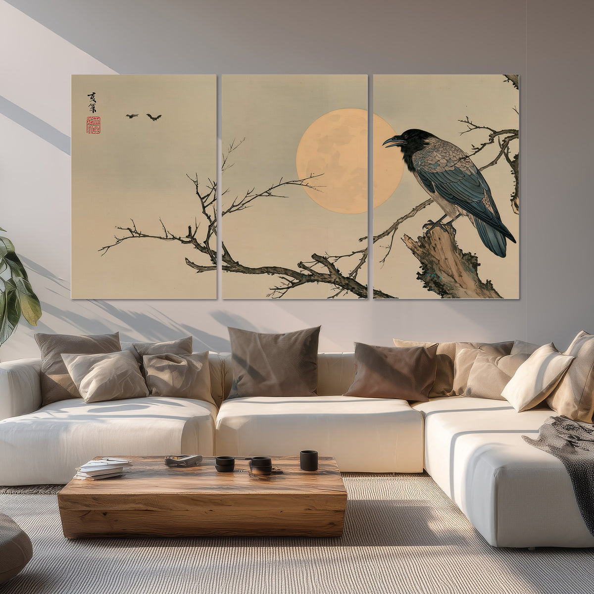 A dark raven perched on a bare branch beside a warm full moon set of 3 poster prints displayed in a living room