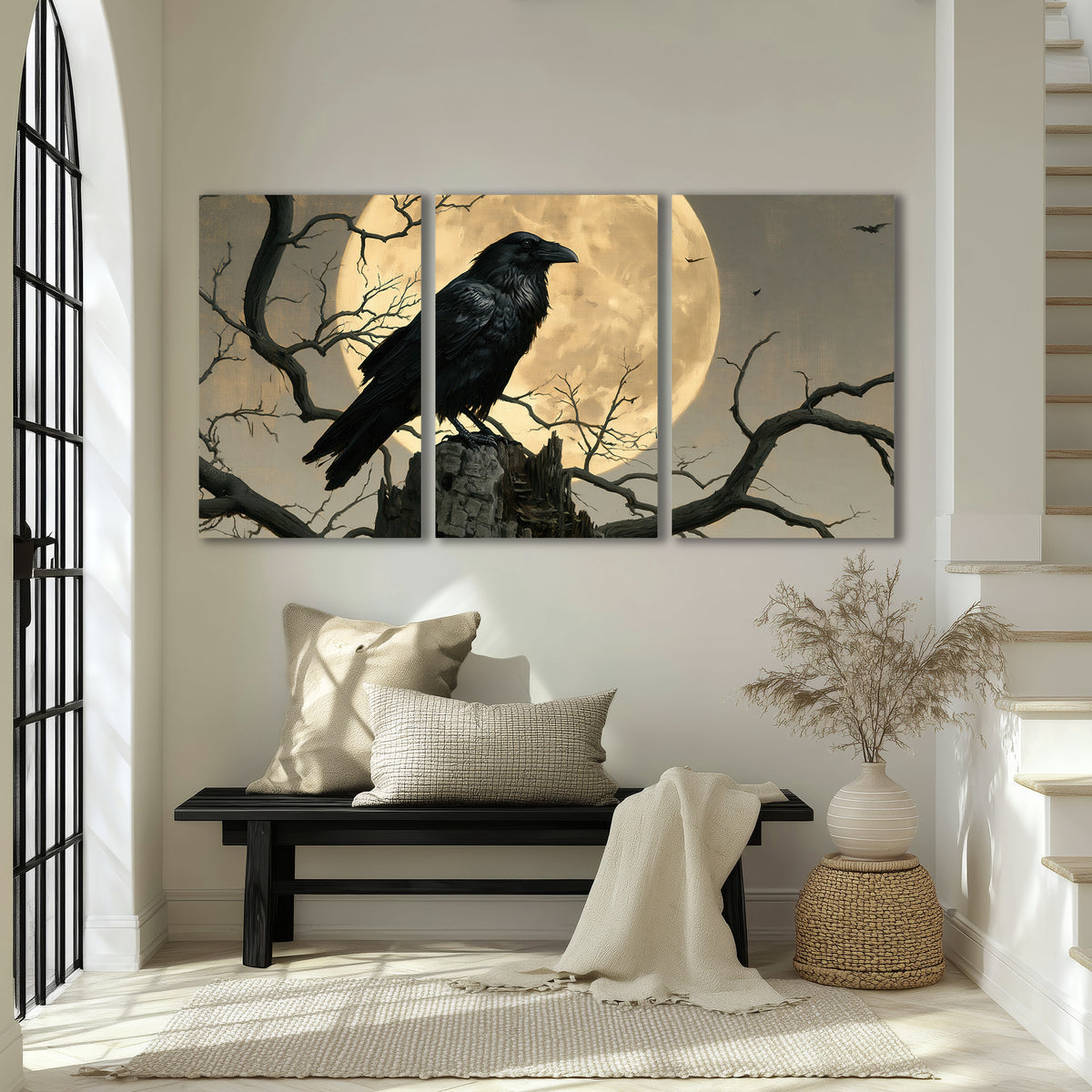 A black raven standing among bare branches in front of a large golden moon 3 piece canvas wall art displayed in a entryway