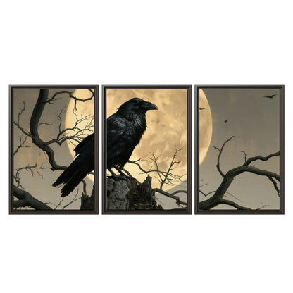 A black raven standing among bare branches in front of a large golden moon 3 piece framed canvas wall art viewed straight on