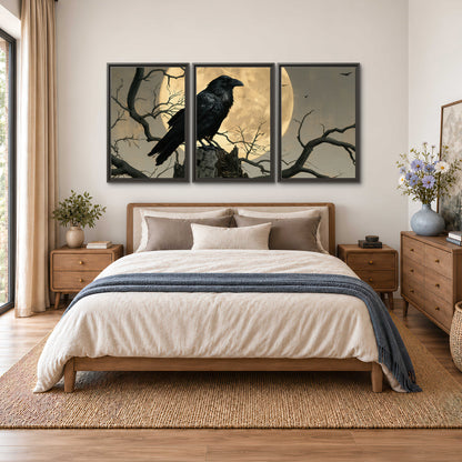 A black raven standing among bare branches in front of a large golden moon 3 piece framed canvas wall art styled in an interior