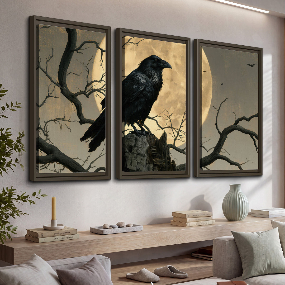 A black raven standing among bare branches in front of a large golden moon 3 piece framed canvas wall art displayed in a console