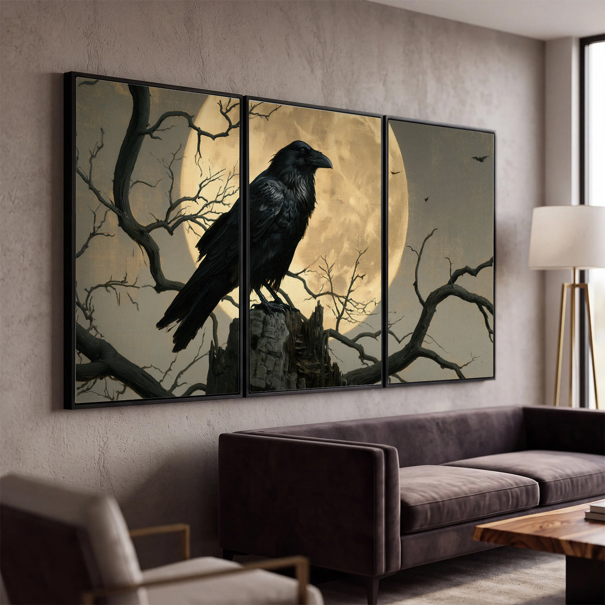 A black raven standing among bare branches in front of a large golden moon 3 piece framed canvas wall art displayed in a modern living room