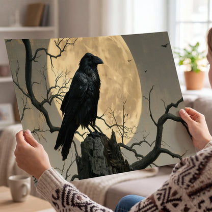 A black raven standing among bare branches in front of a large golden moon single poster print held in hands
