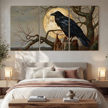 A dark raven perched on a branch beneath a warm moon in a shadowed woodland 3 piece canvas wall art displayed in a bedroom