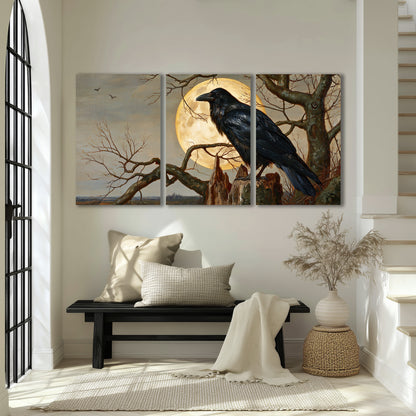 A dark raven perched on a branch beneath a warm moon in a shadowed woodland 3 piece canvas wall art displayed in a entryway