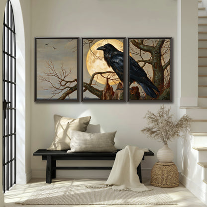 A dark raven perched on a branch beneath a warm moon in a shadowed woodland 3 piece framed canvas wall art displayed in a entryway