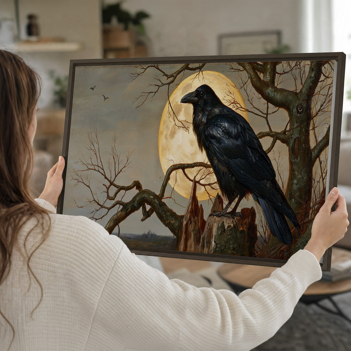 A dark raven perched on a branch beneath a warm moon in a shadowed woodland single framed canvas wall art held in hands