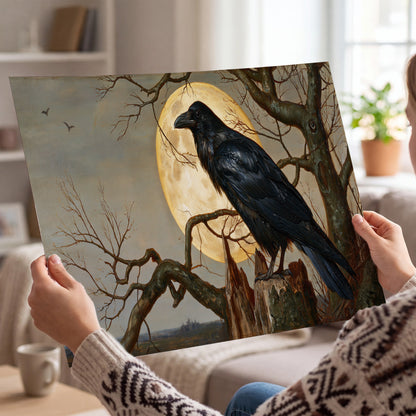 A dark raven perched on a branch beneath a warm moon in a shadowed woodland single poster print held in hands
