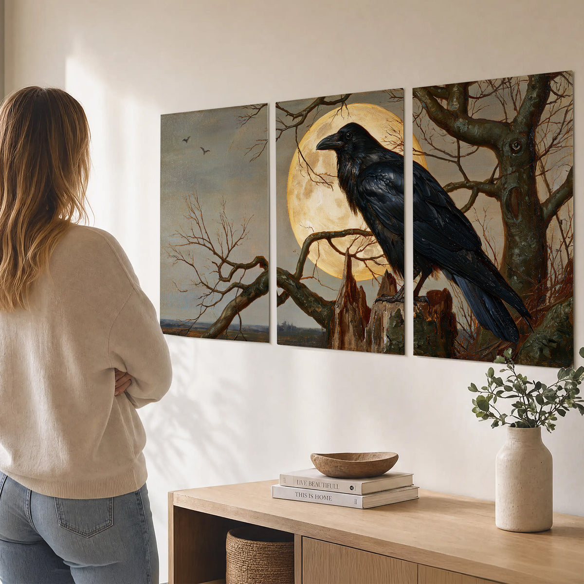 A dark raven perched on a branch beneath a warm moon in a shadowed woodland set of 3 poster prints three panel arrangement on a wall