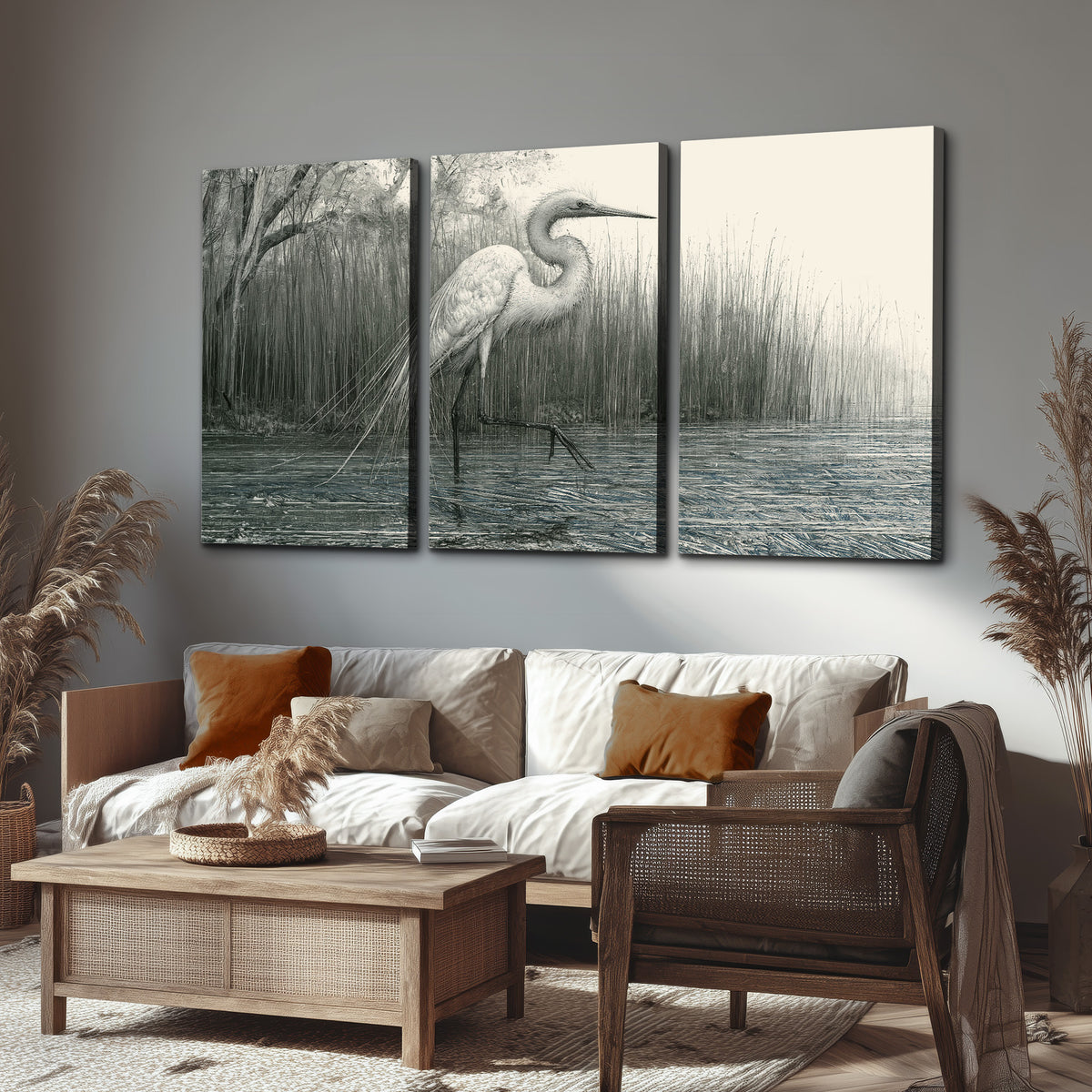 A pale long-legged heron standing beside tall reeds in a muted gray-green wetland 3 piece canvas wall art displayed in a rustic living room