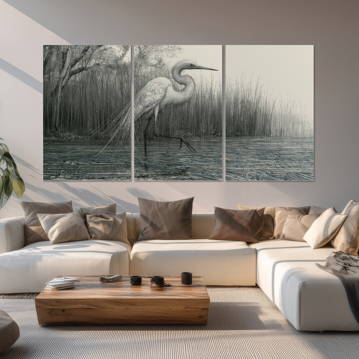 A pale long-legged heron standing beside tall reeds in a muted gray-green wetland set of 3 poster prints displayed in a living room