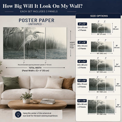 A pale long-legged heron standing beside tall reeds in a muted gray-green wetland set of 3 poster prints size guide above a sofa; room view is illustrative