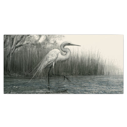 A pale long-legged heron standing beside tall reeds in a muted gray-green wetland single canvas wall art viewed straight on