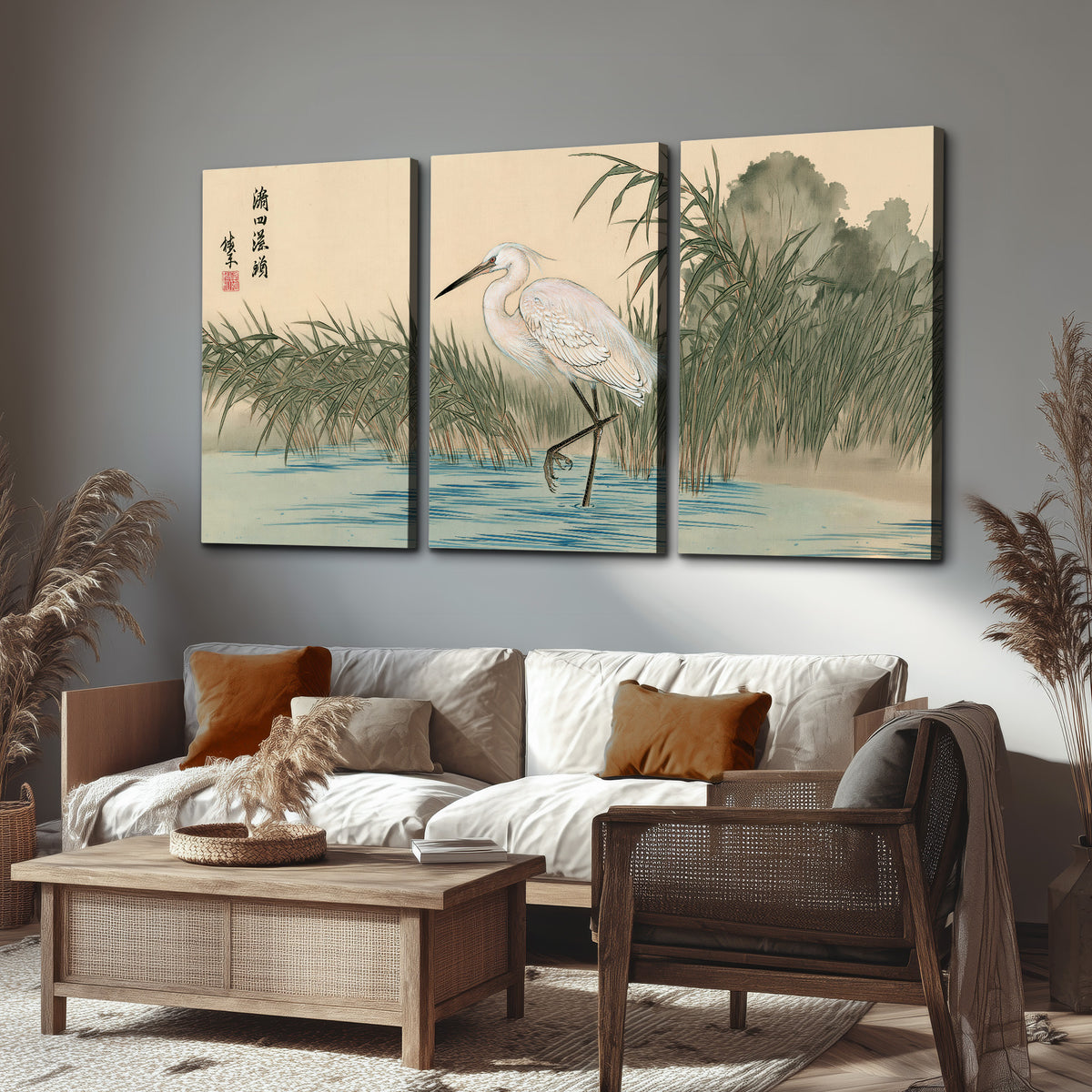 A white heron standing beside a quiet river with reeds and distant hills 3 piece canvas wall art displayed in a rustic living room