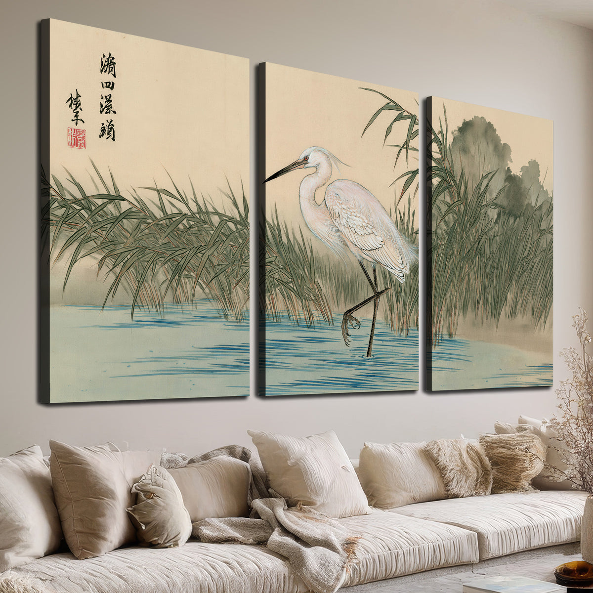 A white heron standing beside a quiet river with reeds and distant hills 3 piece canvas wall art room and product view