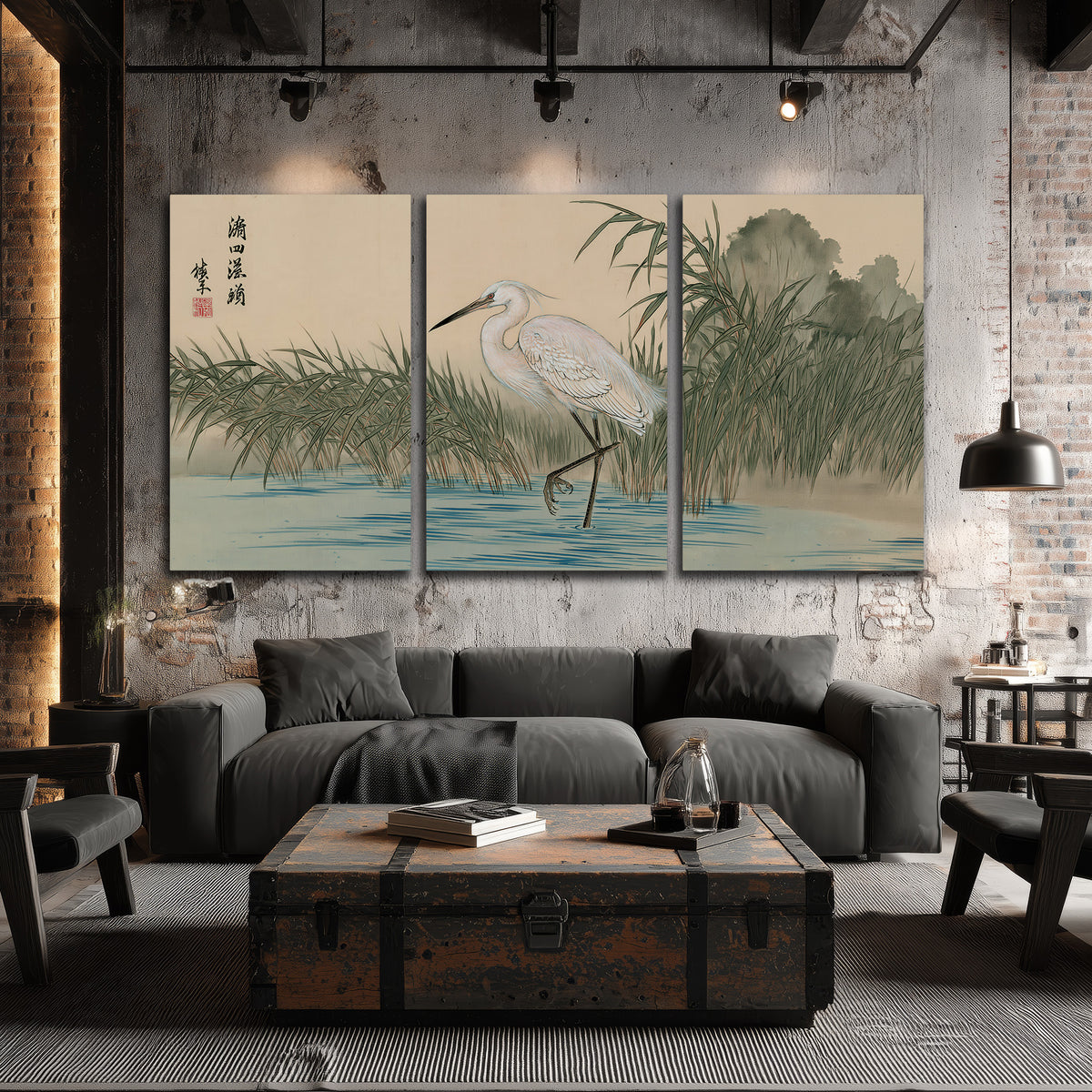 A white heron standing beside a quiet river with reeds and distant hills 3 piece canvas wall art displayed in a industrial room