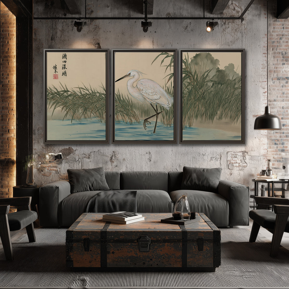 A white heron standing beside a quiet river with reeds and distant hills 3 piece framed canvas wall art displayed in a industrial room