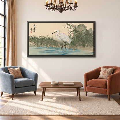 A white heron standing beside a quiet river with reeds and distant hills single framed canvas wall art styled in an interior