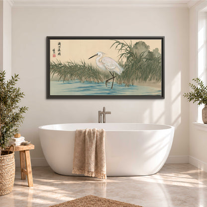 A white heron standing beside a quiet river with reeds and distant hills single framed canvas wall art styled in an interior