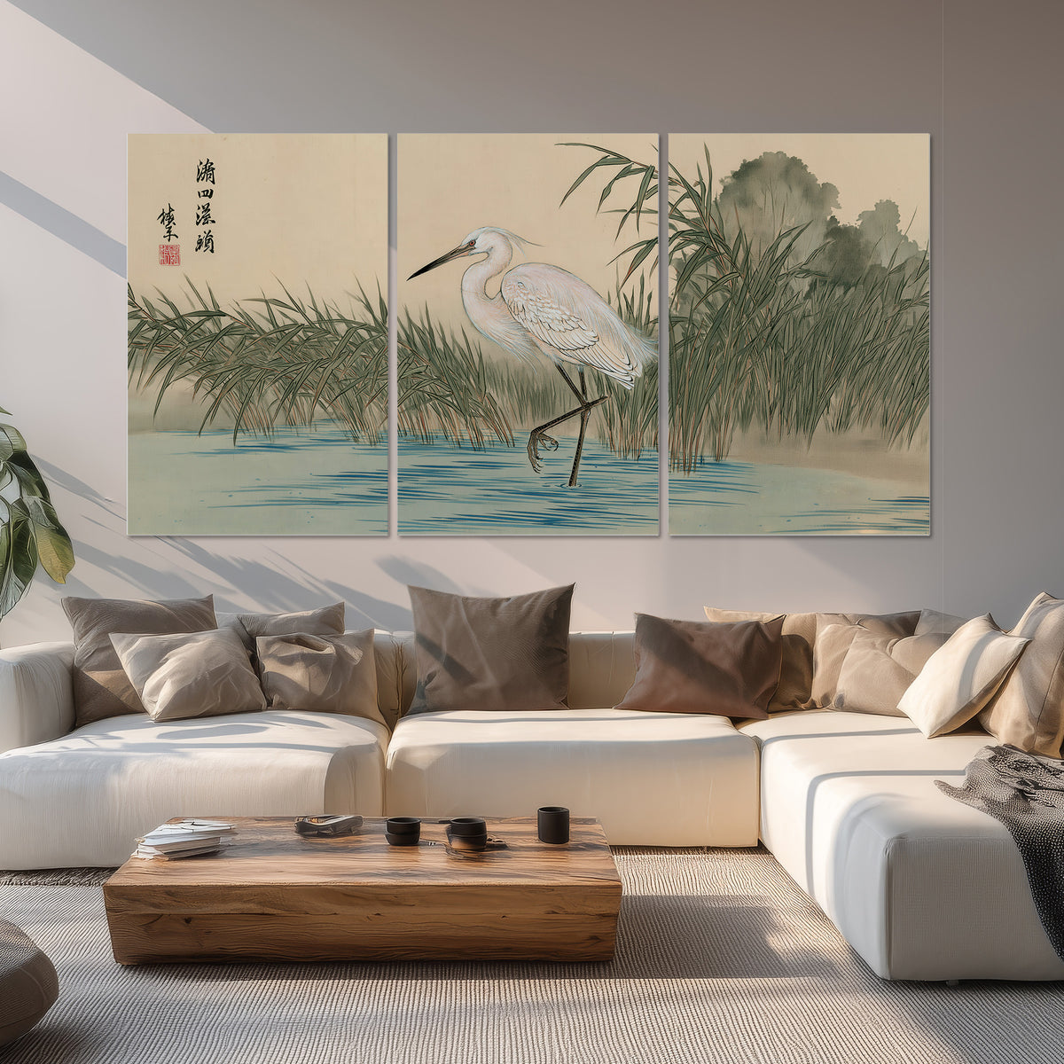 A white heron standing beside a quiet river with reeds and distant hills set of 3 poster prints displayed in a living room