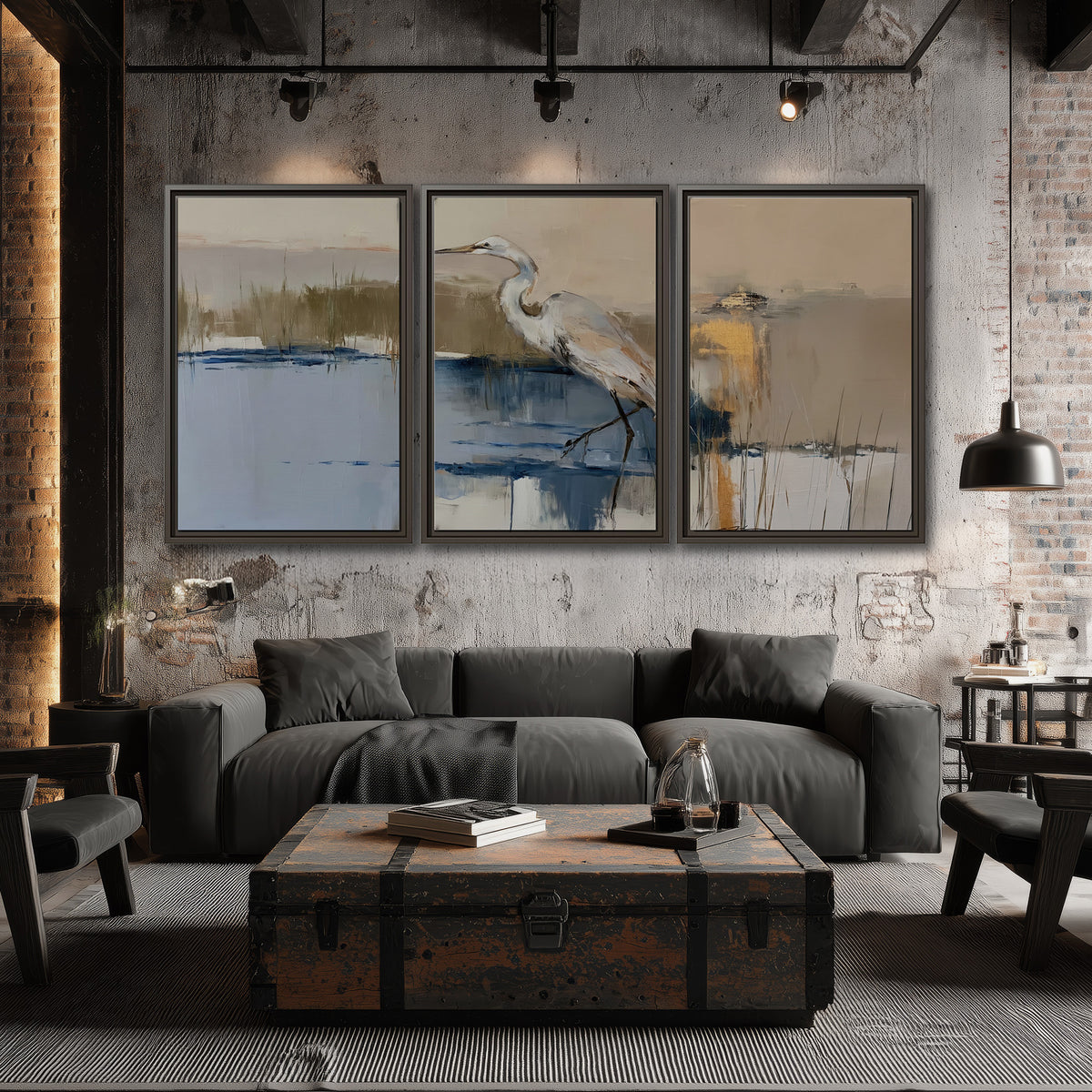A slender heron standing in blue water among loose ochre and cream brushstrokes 3 piece framed canvas wall art displayed in a industrial room