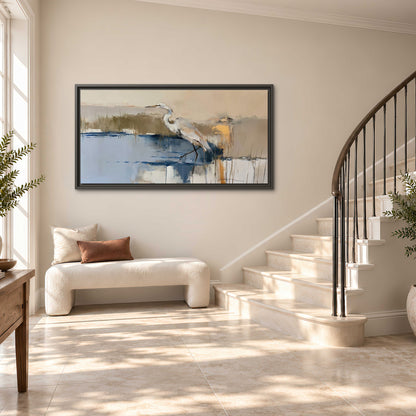 A slender heron standing in blue water among loose ochre and cream brushstrokes single framed canvas wall art styled in an interior
