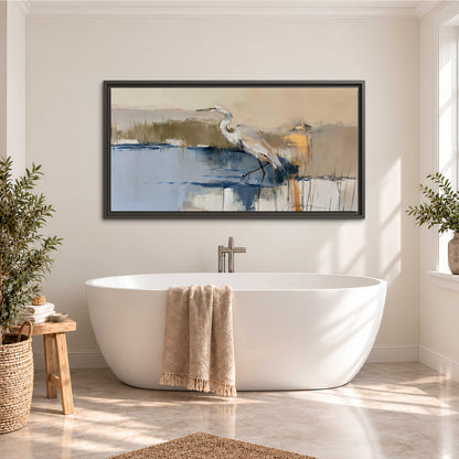 A slender heron standing in blue water among loose ochre and cream brushstrokes single framed canvas wall art styled in an interior