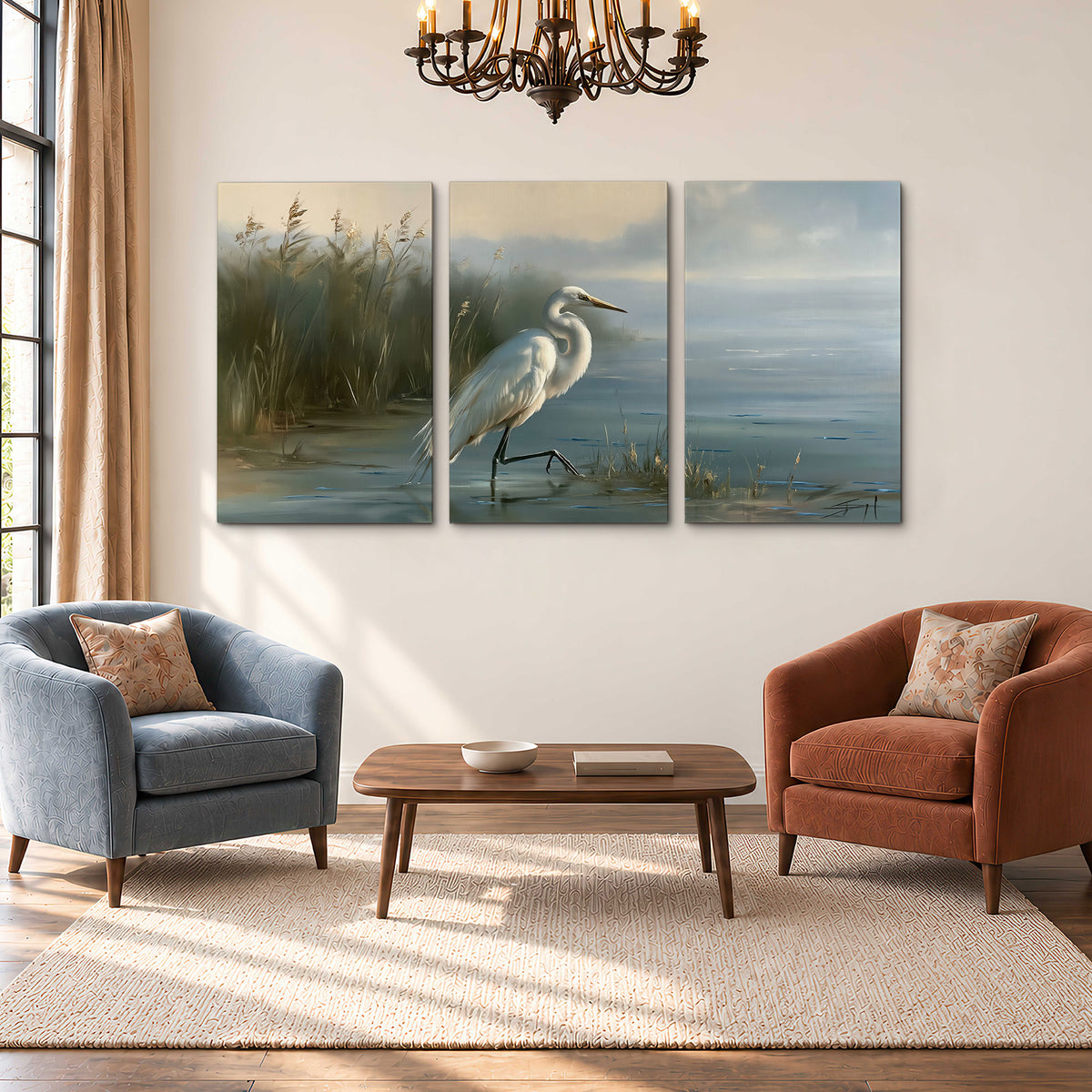 A white heron beside tall marsh grasses and still blue water 3 piece canvas wall art styled in an interior