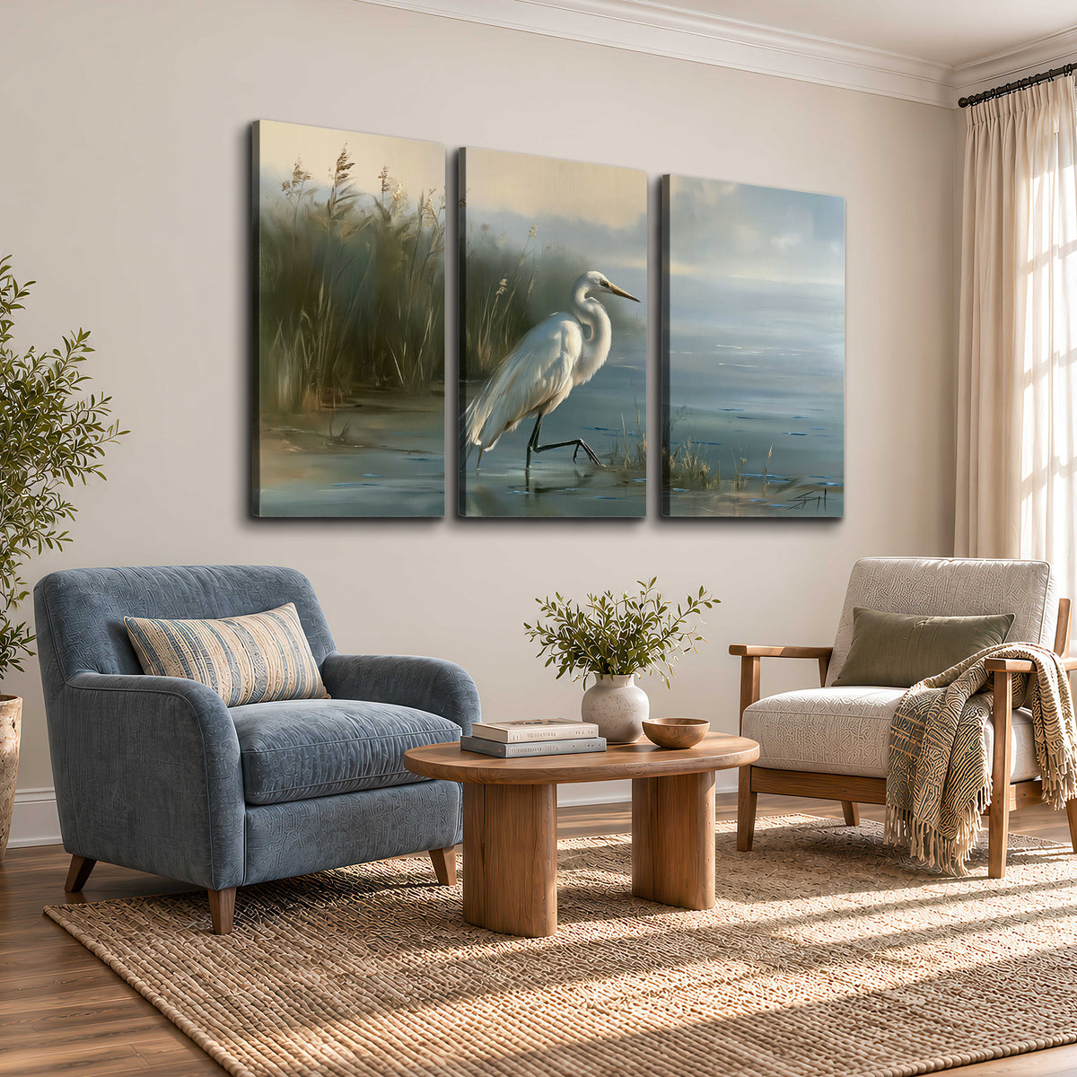A white heron beside tall marsh grasses and still blue water 3 piece canvas wall art styled in an interior