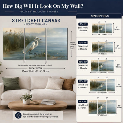 A white heron beside tall marsh grasses and still blue water 3 piece canvas wall art size guide above a sofa; room view is illustrative